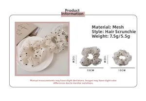 Detail of white lace mesh scrunchie with black bow pattern and size measurements
