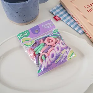 Detail of candy-colored elastic hair bands in macaron pink, purple, and mint green