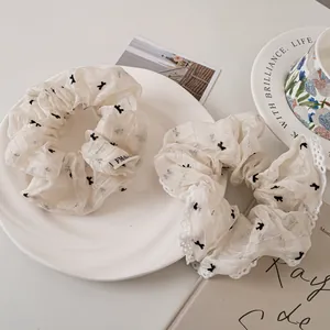 Elegant white lace scrunchie set with mesh bow and subtle patterns for summer hair styling