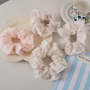 Polka dot lace hair scrunchies in pastel macaron colors with soft fabric texture