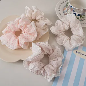 Lace-trimmed polka dot hair scrunchies set in pink, purple, and green cotton fabric
