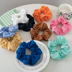 Set of 9 colorful matte cotton scrunchies with fabric labels for summer hairstyling