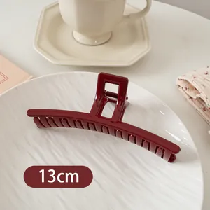 Makroaufnahme einer 13cm burgunderroten glänzenden Haarklammer für elegante Frisuren