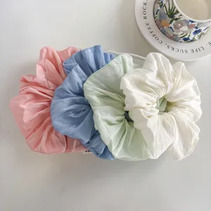 Set of four oversized macaron colored scrunchies in pastel chiffon with pleated texture