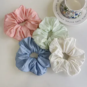 Set of four pastel oversized fabric scrunchies in pink, green, blue and cream white colors