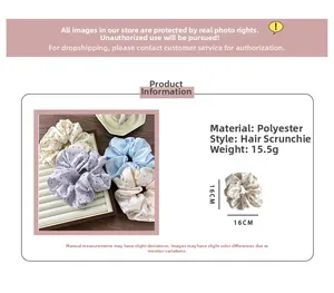 Detailed view of polka dot satin scrunchies in purple and blue with 16cm size specs