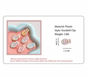 Detail of fish-shaped plaid duckbill hair clips showing 3.5cm size and plastic material