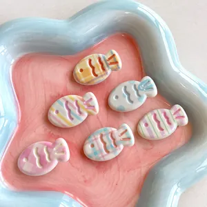 Set of 6 cute macaron resin fish hair clips with plaid and stripe patterns on a plate