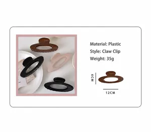 Detail of minimalist hollow oval hair claws showing 12cm size and 35g weight specs
