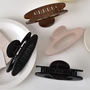Minimalist oval hollow hair claws in matte black, caramel brown, and nude pink finishes