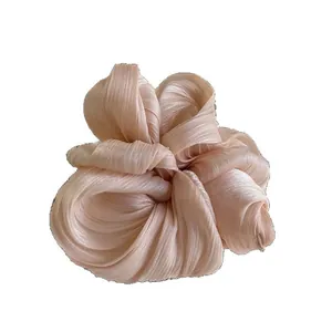 Elegant champagne pleated satin oversized scrunchie with a lustrous silky finish