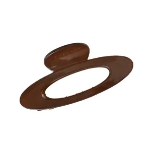 Minimalist oval hollow hair claw clip in amber brown with high gloss finish