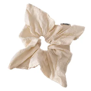 Minimalist cream floral embroidered scrunchie with FMdrea label for elegant hair styling