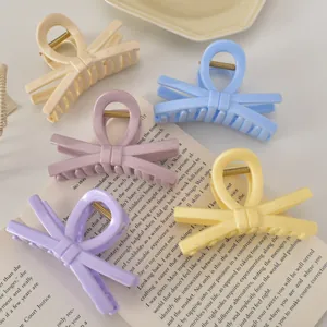 Cinq pinces à cheveux en forme de nœud aux couleurs macaron : crème, bleu et rose