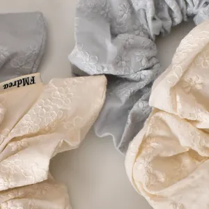 Floral embroidery cotton scrunchies in cream and light blue with delicate eyelet detail