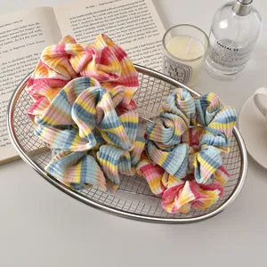 Detail of colorful striped fabric scrunchies with elastic texture in a decorative basket