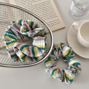 Detail of colorful ribbed stripe scrunchies in various pastel shades for hair styling