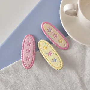 Lot de trois pinces à cheveux étoiles colorées avec pois roses et motifs jaunes