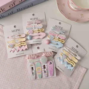 Close-up of pastel floral and plaid hair clip sets with bows and heart details