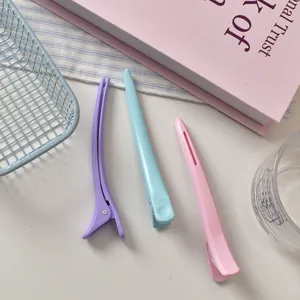 Macro shot of 12cm matte hair clips in pastel purple, blue, and pink colors