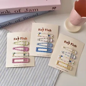 Cute colorful polka dot hair clip set for girls on decorative macaron background