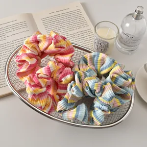 Set of two colorful striped scrunchies in stylish blue and pink textured fabric