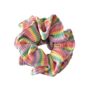 Rainbow striped oversized scrunchie with ribbed fabric and vibrant Y2K aesthetic