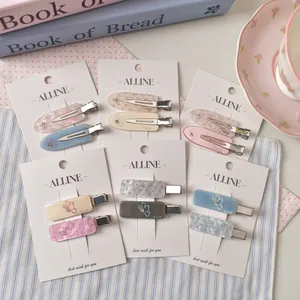 Chic acrylic hair clips with floral and butterfly patterns on display card