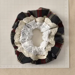 Detail of vintage plaid scrunchie with layered lace edges and size reference scale