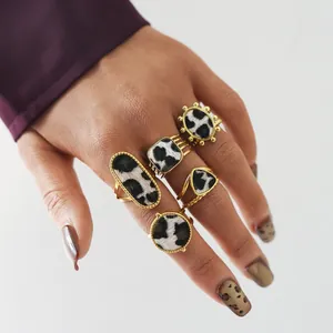 Detail of vintage gold rings set featuring leopard print horsehair textures on hand