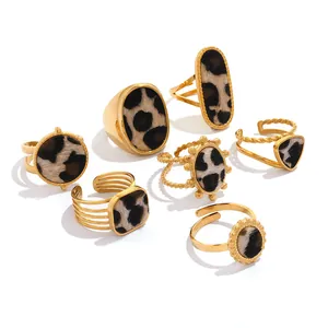 Golden geometric ring set featuring leopard print faux fur and textured metal bands