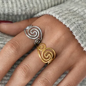 Elegant gold and silver stainless steel rings with minimalist hollow swirl design on fingers