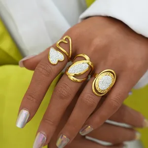 Close-up of three gold-plated titanium steel rings set with crystals on a hand