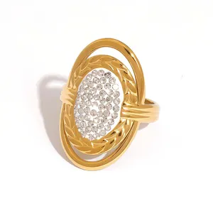 Golden titanium steel ring with pavé rhinestones in an oval tiered statement design