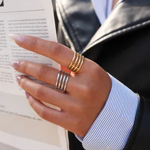 Minimalist layered 18K gold and silver wide multi-layer rings on model for trendy look