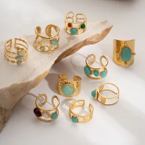 Detail of 9-piece vintage gold stainless steel ring set with assorted natural stones