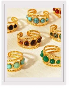 Detail of vintage 18K gold plated rings featuring multi-layer twist bands and colorful stones