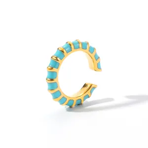Modern 18K gold plated C-shaped ear cuff with sky blue enamel details on white background