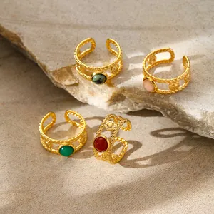 Adjustable gold twisted rope rings with various natural stone cabochons on stone