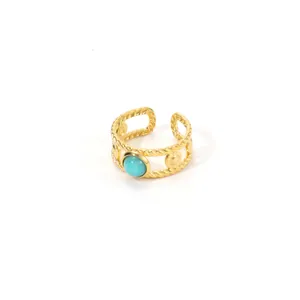 Gold plated stainless steel rope ring featuring a polished turquoise stone centerpiece