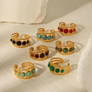 Detailed macro view of 18K gold plated stainless steel rings with colorful natural stones