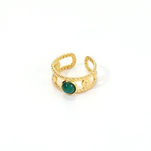 Adjustable gold twisted ring with sun relief and a polished green natural stone