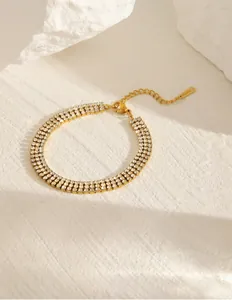Detailed macro shot of three-row zircon gold bracelet with adjustable clasp