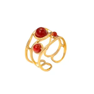 Detail of vintage 18K gold plated ring with red agate beads and hollow curved metal