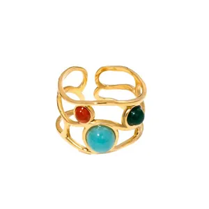 Detail of vintage 18K gold plated stainless steel hollow ring with three natural stones