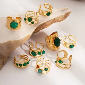 Detail view of retro 18K gold plated stainless steel rings set with green natural stones