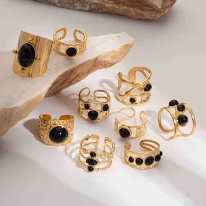 Detail of vintage 18K gold plated stainless steel rings with black natural stones