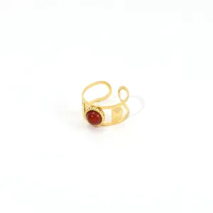 Detailed macro view of retro 18K gold stainless steel ring with red gemstone inlay