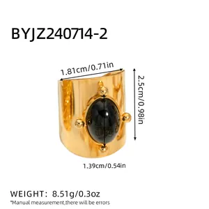 Detailed view of vintage gold ring with large black stone and dimensional measurements