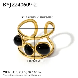 Exaggerated gold stainless steel open ring featuring three black oval gemstones